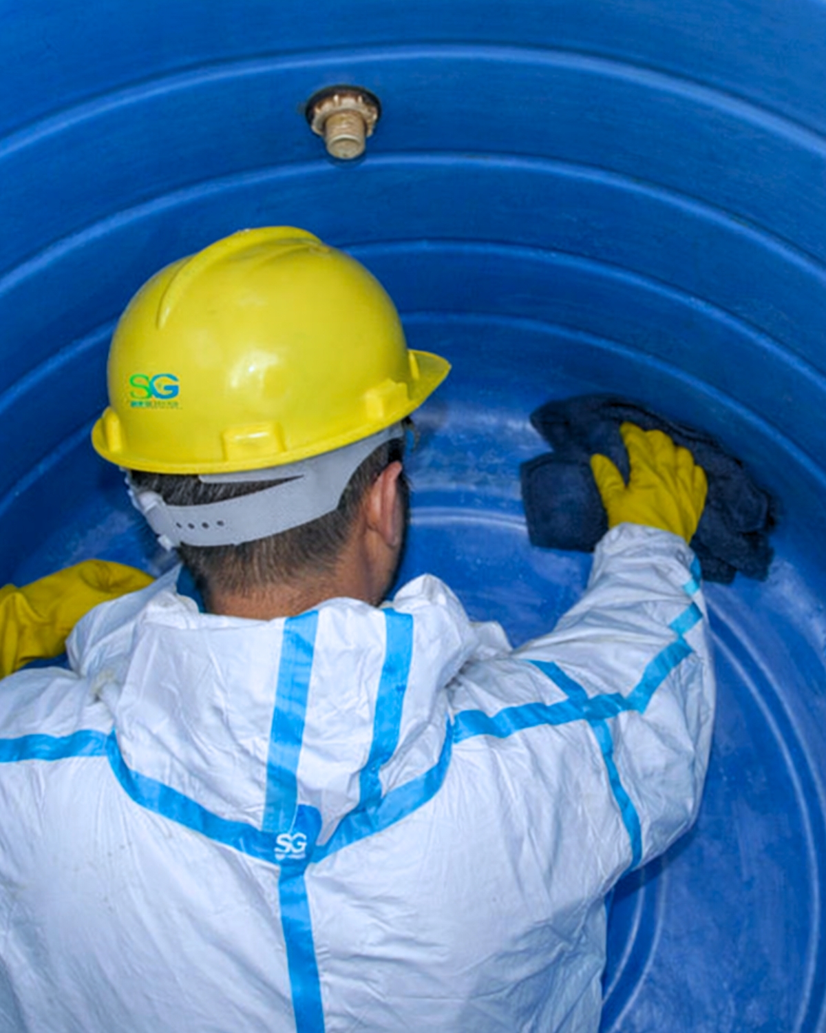 Megameter technician cleaning inside a water tank