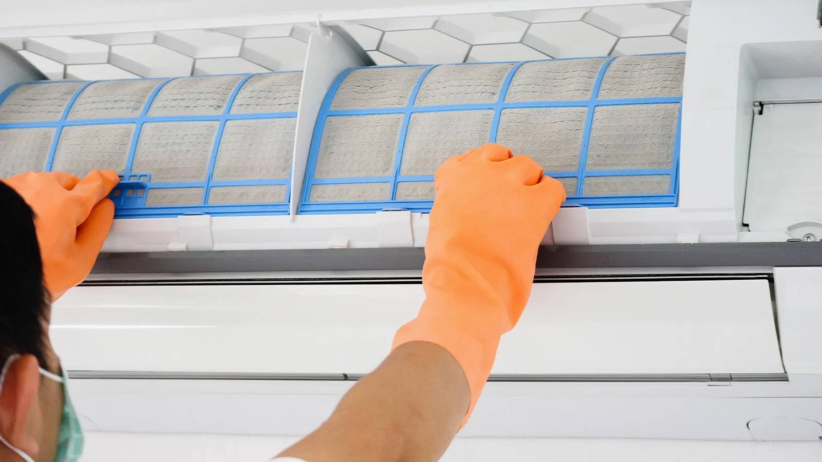 Technician performing AC duct cleaning using professional equipment in a Dubai home.