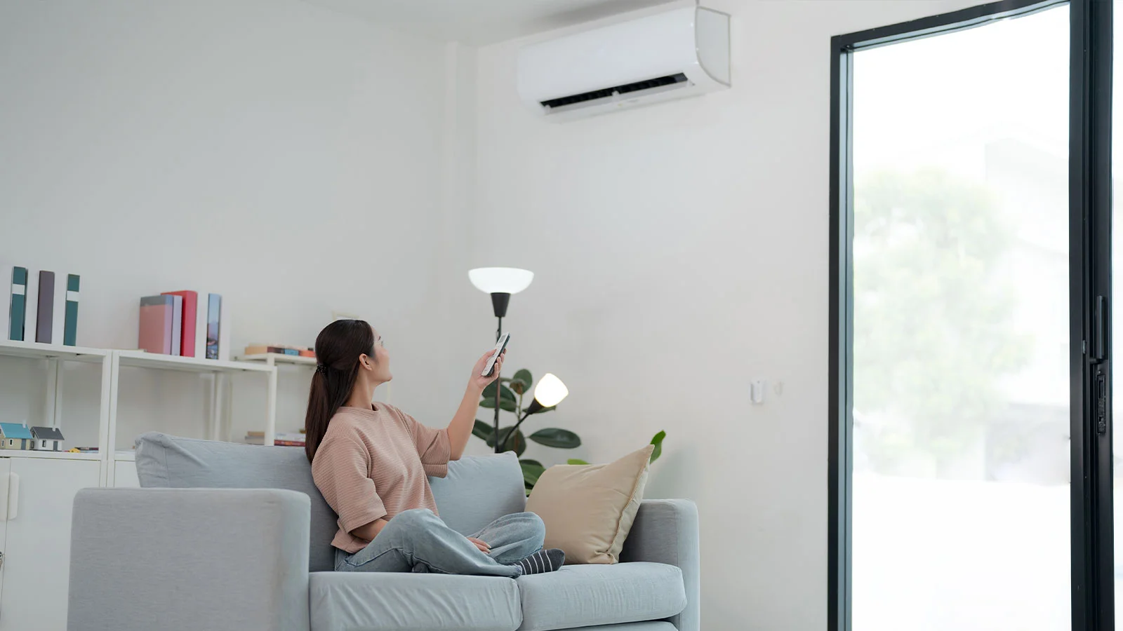 A Mega Meter technician using a vacuum to clean an AC duct in a UAE home, showing the professional duct cleaning process