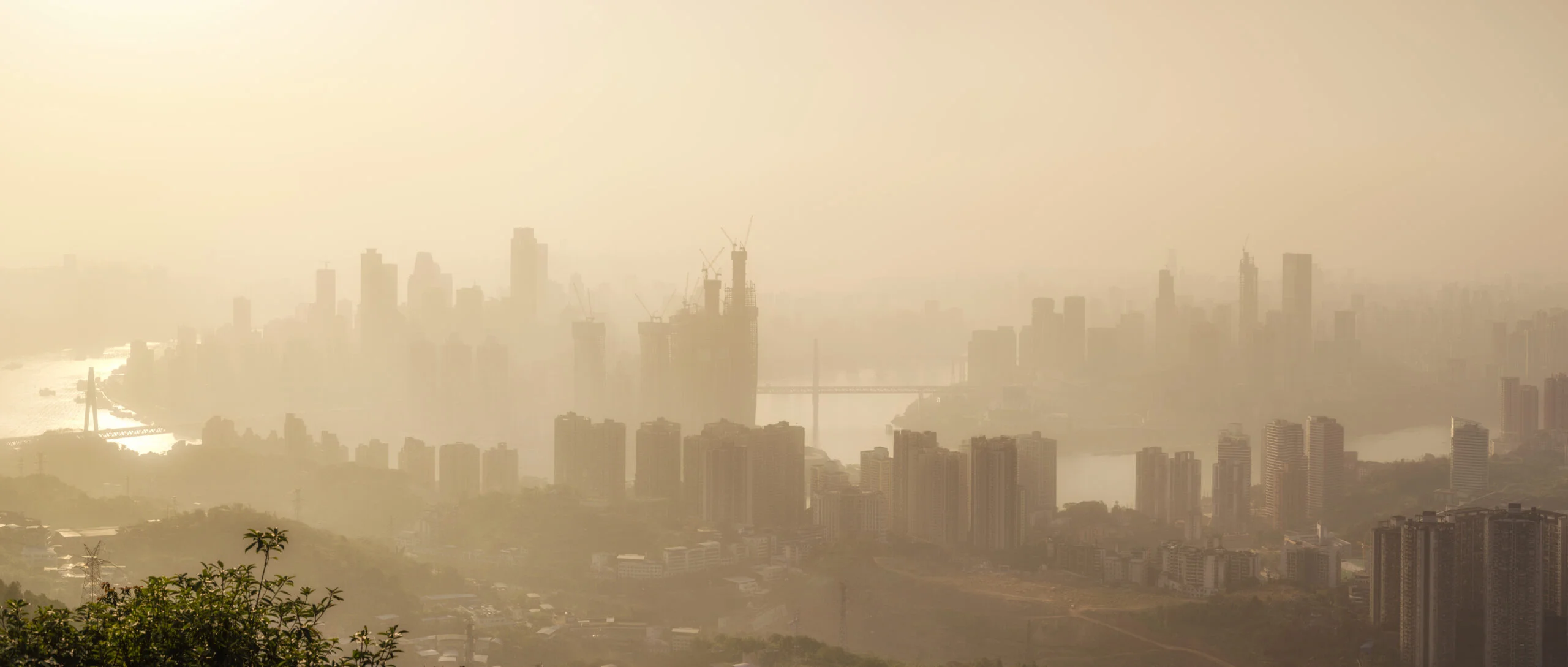 Shamal dust storm sweeping over a UAE city skyline with fine sand settling on rooftop AC units and ventilation grilles