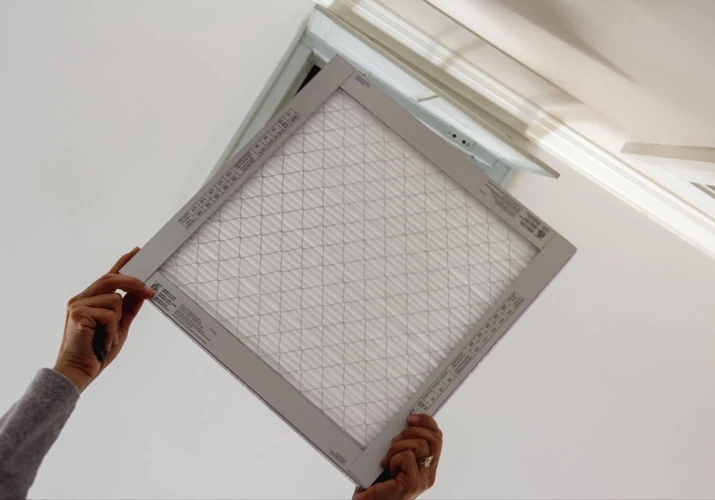A wall calendar beside a ceiling AC vent in a UAE home, illustrating how often to clean AC ducts.