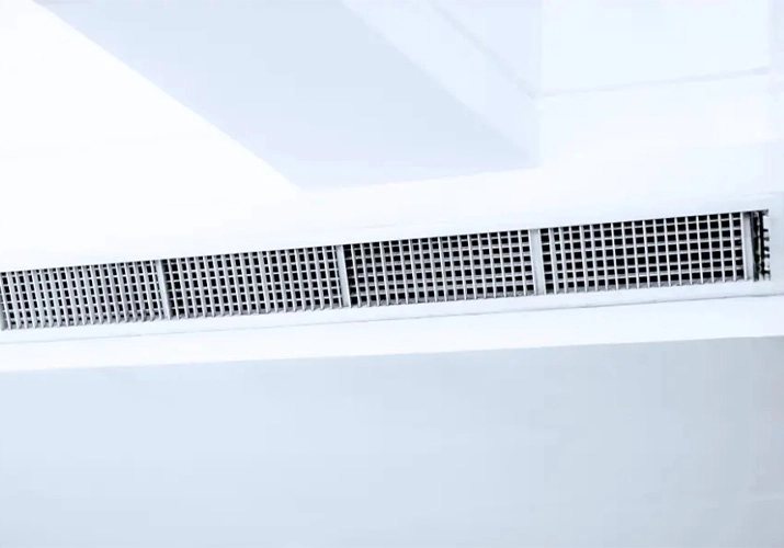 Fine construction dust and paint residue around an AC vent in a newly renovated Dubai apartment
