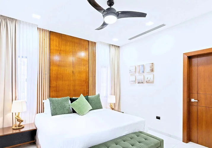 A bright Dubai apartment being cleaned in early autumn, with AC vents, a water tank, and soft furnishings in view.